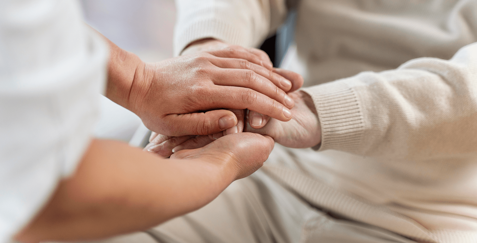 doctor-holding-hands-with-senior-patient 1-min